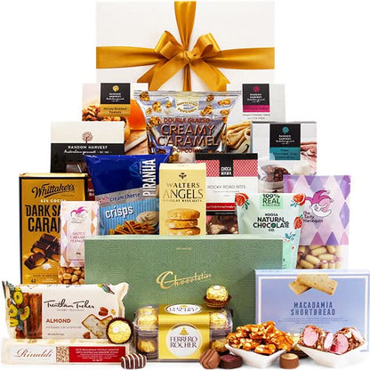 Gourmet gift basket with a variety of snacks and chocolates on a white background
