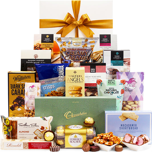 Gourmet gift basket with a variety of snacks and chocolates on a white background